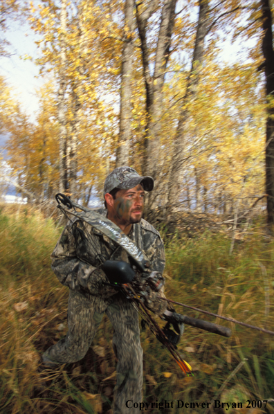 Bow hunter in forest.