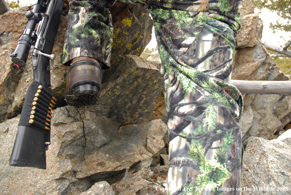 Big game hunter climbing