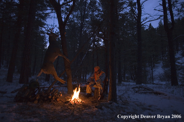 Deer hunter with bagged deer in camp in winter.  