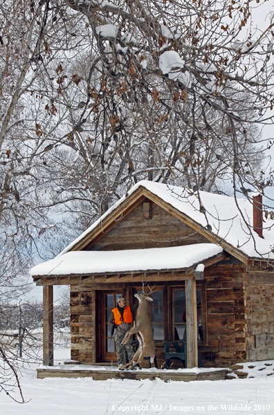 Hunter with bagged buck. 