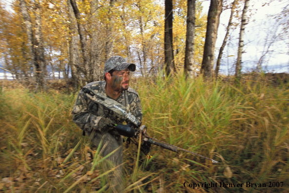 Bow hunter in forest.