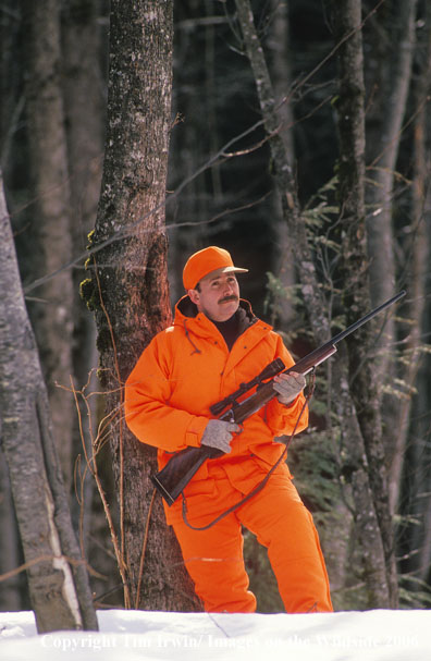 BIg game hunter in field during winter.
