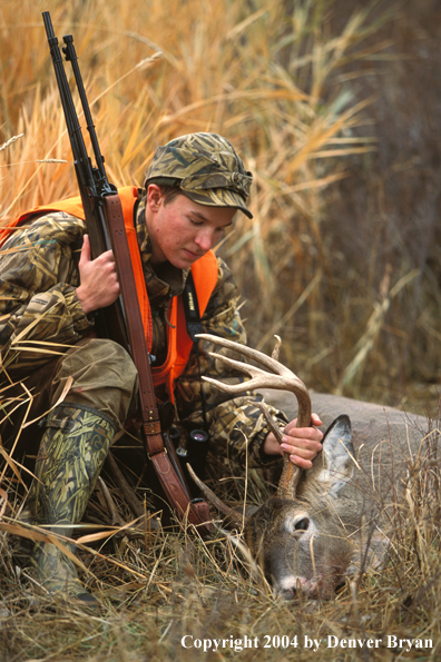Hunter with bagged white-tailed deer.
