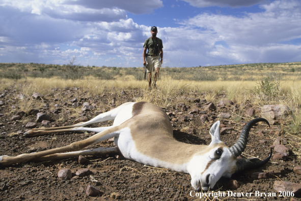 African hunter walking toward kill.