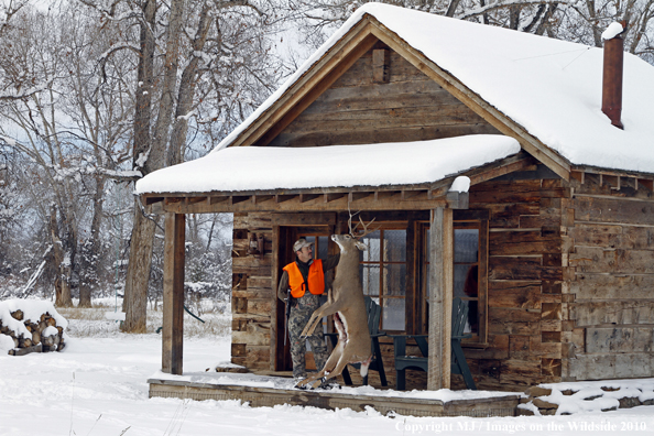 Hunter with bagged buck. 