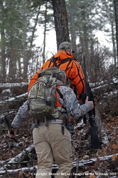 Big game hunters hiking game trail for elk.