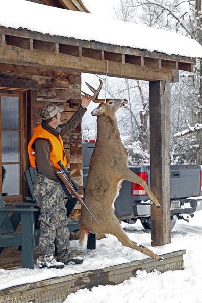 Hunter with bagged buck. 