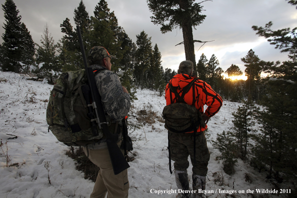 Big game hunters hiking game trail for elk.