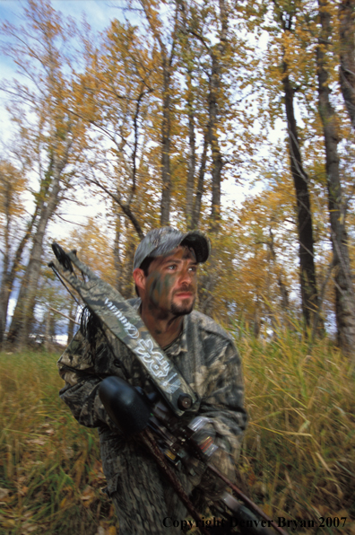 Bow hunter in forest.