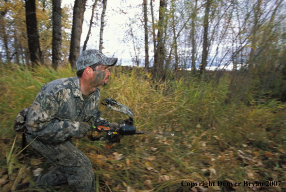 Bow hunter in forest.