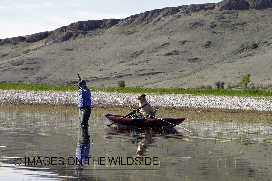 Bowfisherman shooting at fish.