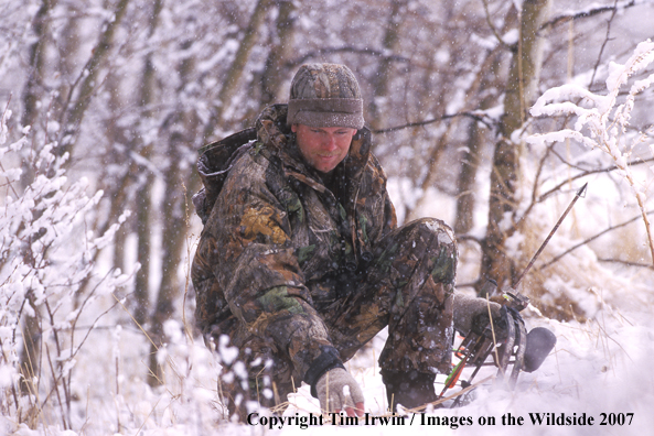 Bowhunter tracking in winter.