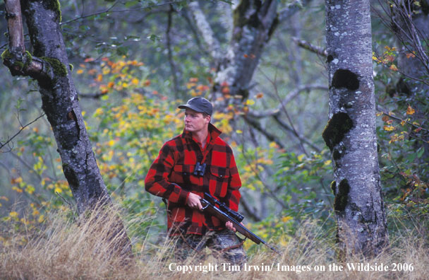 Big game hunter in field.