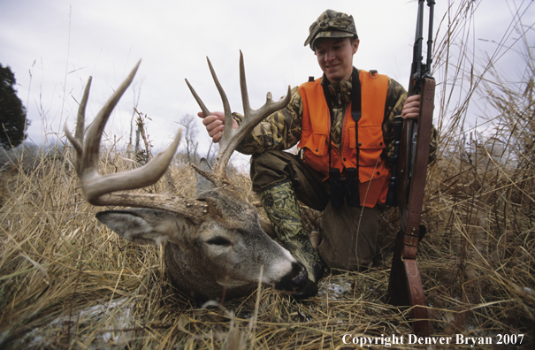 Hunter with downed white-tail deer