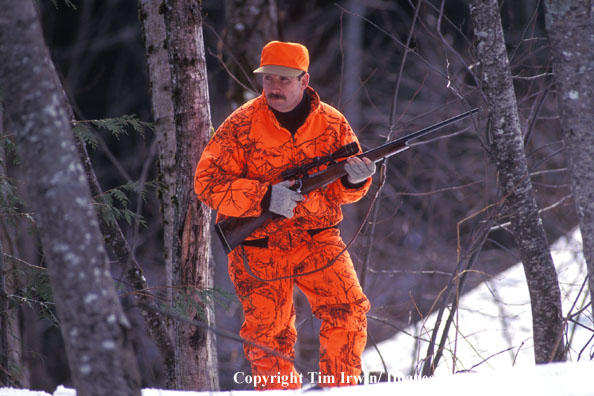 BIg game hunter in field during winter.