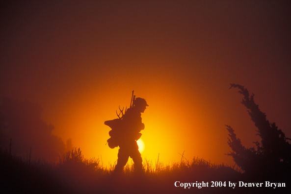 Big game hunter packing out his kill.