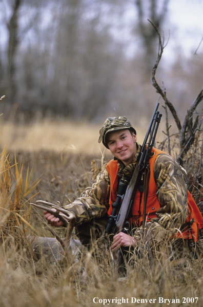 Hunter with downed white-tail deer