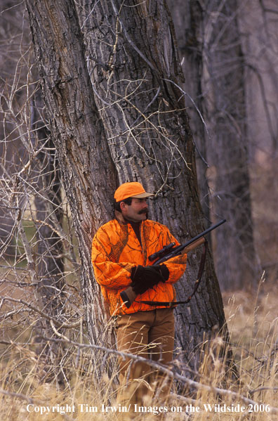 Big game hunter in field.