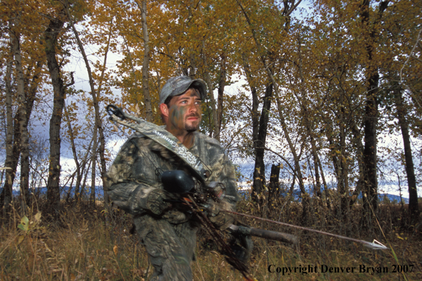 Bow hunter in forest.