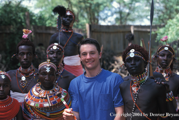 Tourist with Samburu dancers.  Kenya, Africa