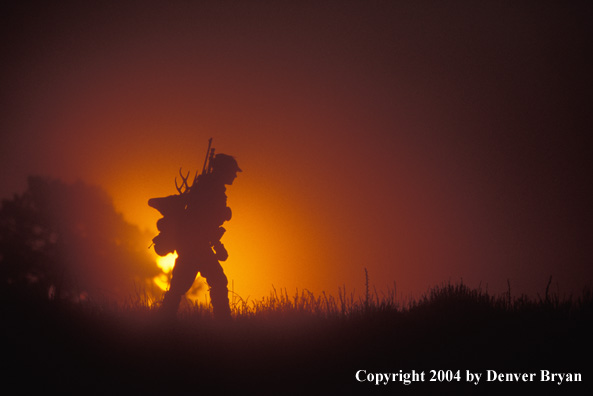 Big game hunter packing out his kill.