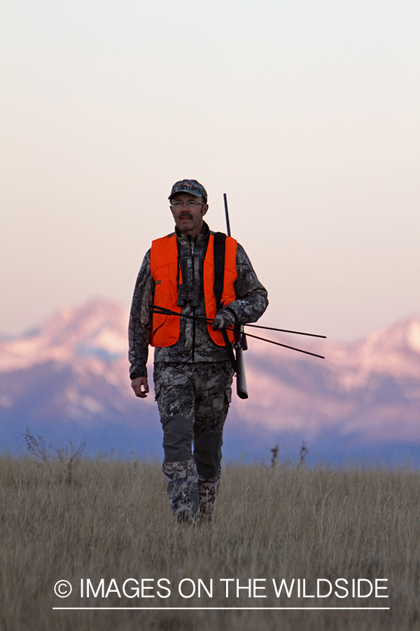 Big game hunter in field. 