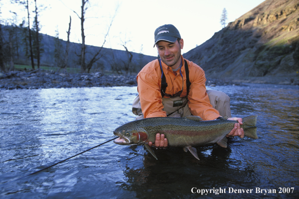 Flyfisherman releasing steelhead.