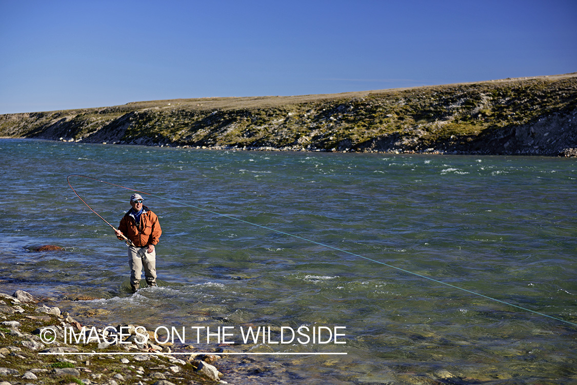 Flyfisherman fighting with Arctic Char.