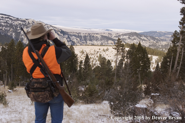 Big game hunter glassing for game.