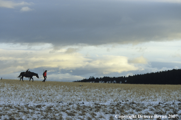 Big game hunter walking back to camp at dusk