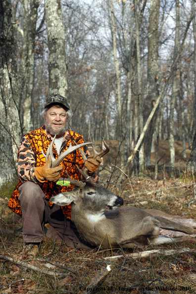 White-tailed deer hunter with bagged buck.