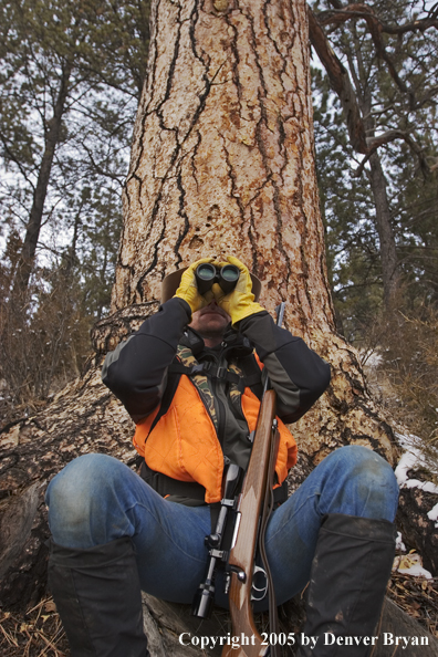 Big game hunter glassing for game.