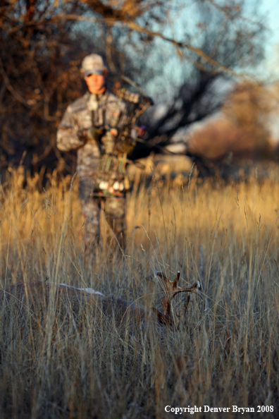 Bowhunter approaching kill