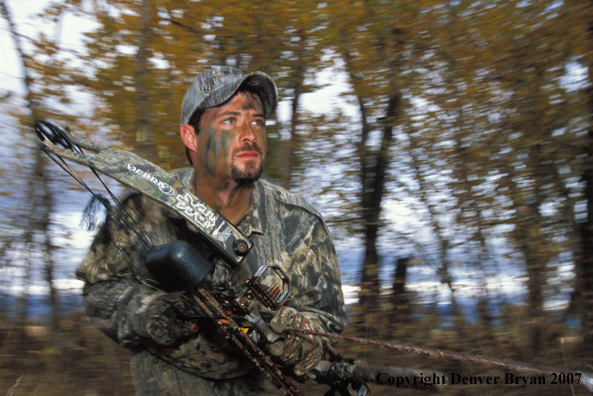Bow hunter in forest.