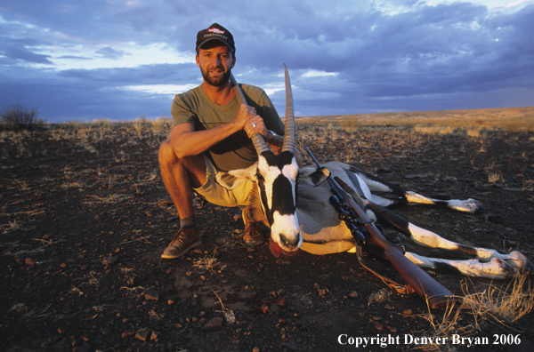 African hunter with downed oryx.