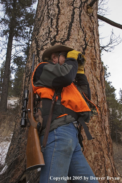 Big game hunter glassing for game.