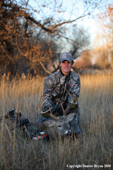 Bowhunter with Whitetail Deer