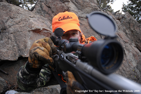 Big game hunter chcecking gun