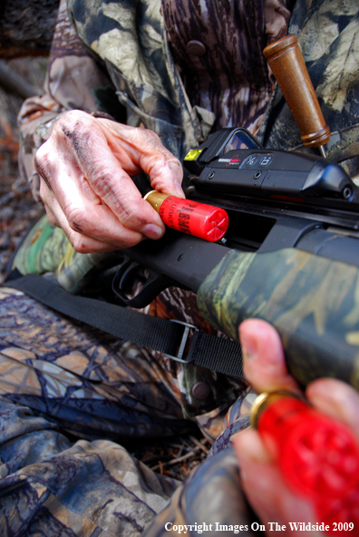 Hunter loading shotgun shells.