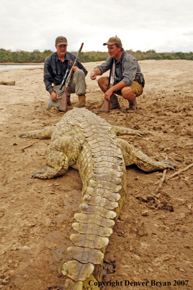 Hunters with bagged African crocodile