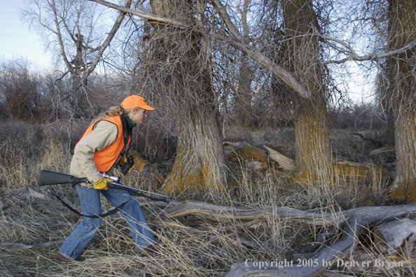 Woman big game hunter stalking game.