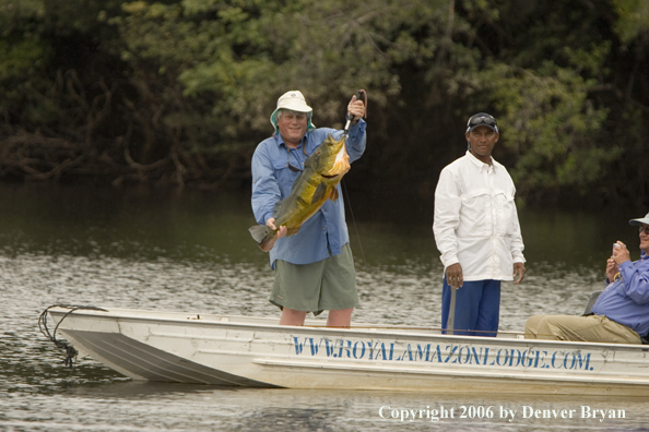 Fisherman holding Peacock bass