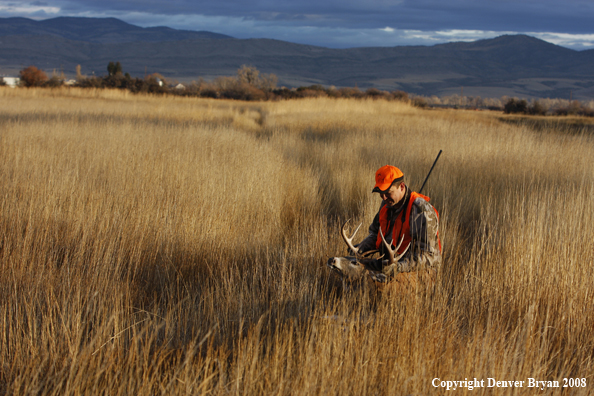 Hunter with Whitetail Deer