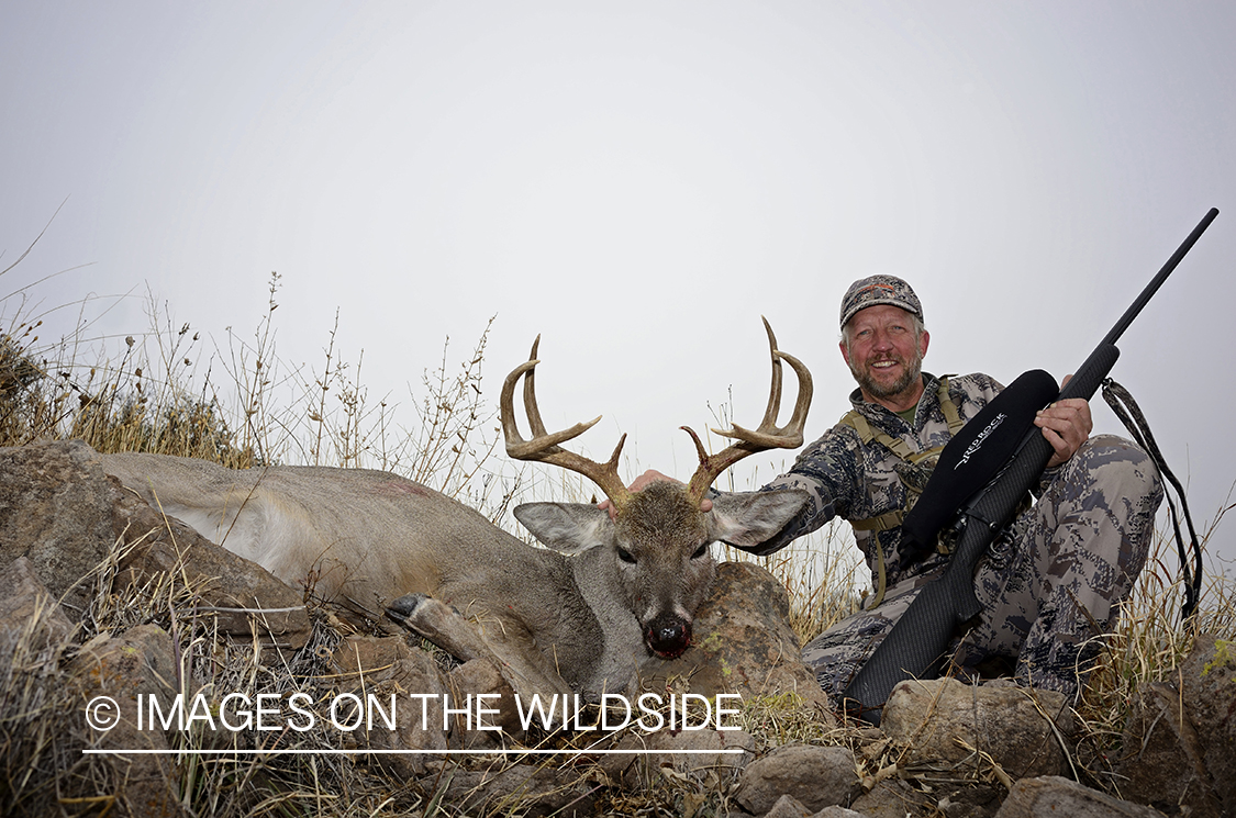 Hunter with Coues deer buck.