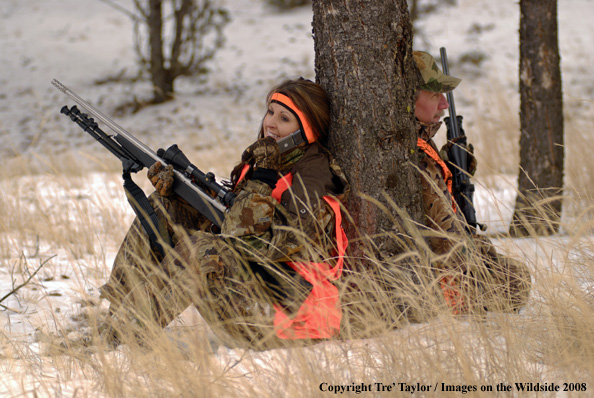 Hunter talking on cell phone while in field