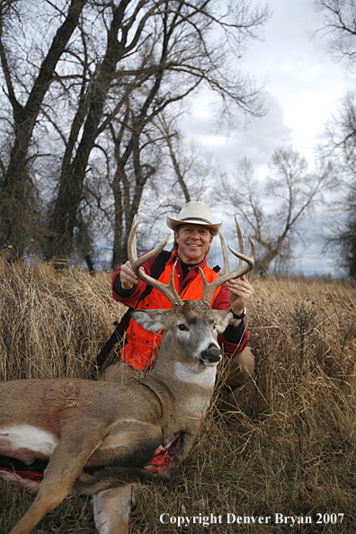 Hunter in field with bagged deer