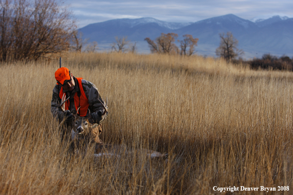 Hunter with Whitetail Deer