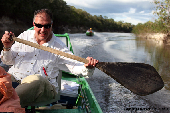 Flyfisherman rowing