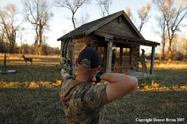 Archery hunter aiming at target
