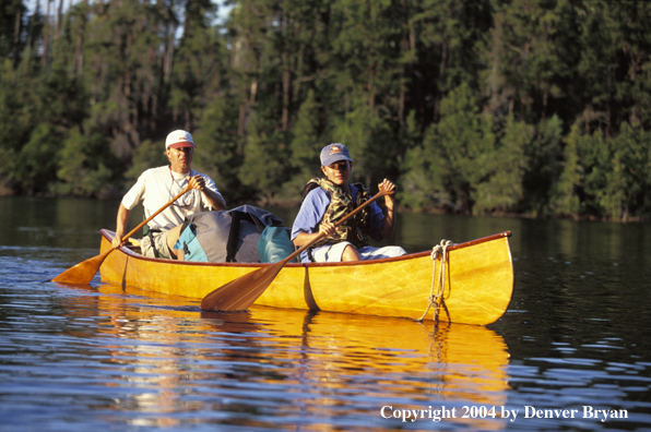 Father and son paddling cedar canoe.